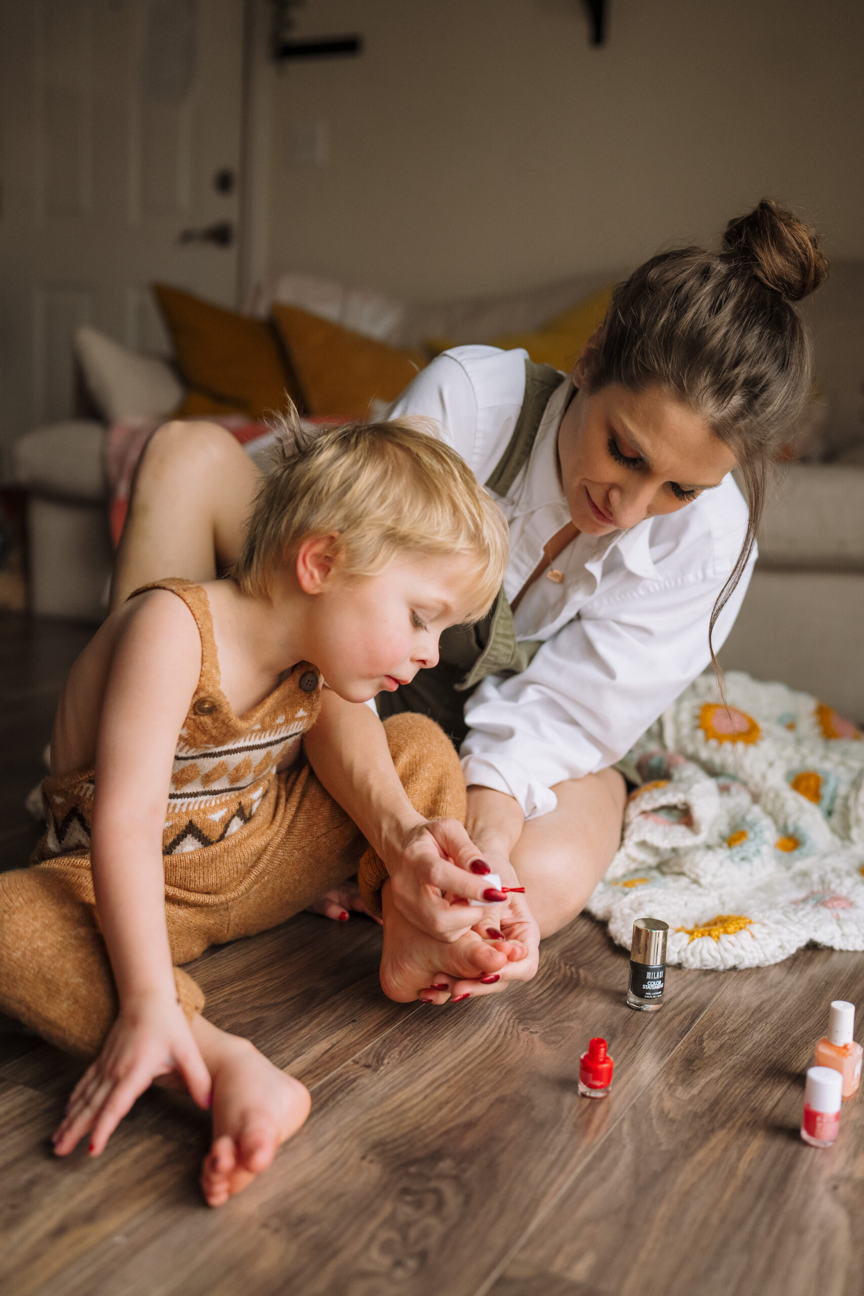 a woman and child painting nails